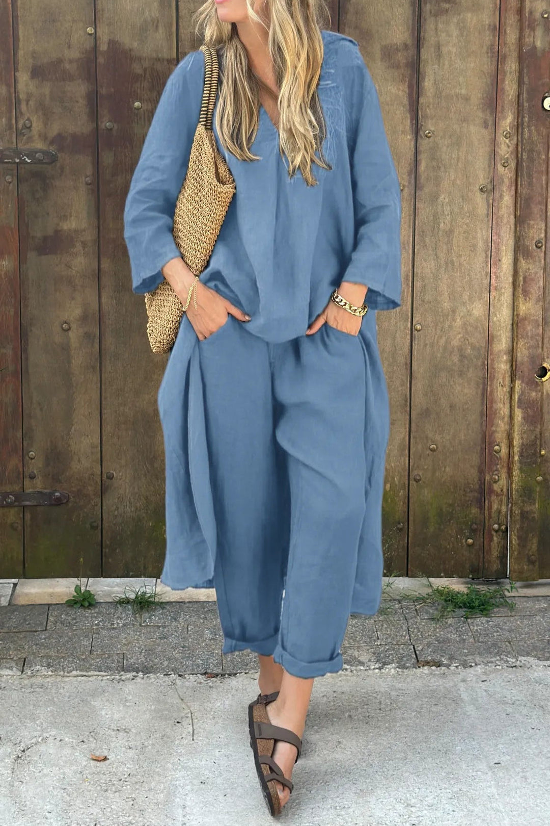 Blue comfortable set with woven bag, styled outside with wooden wall.