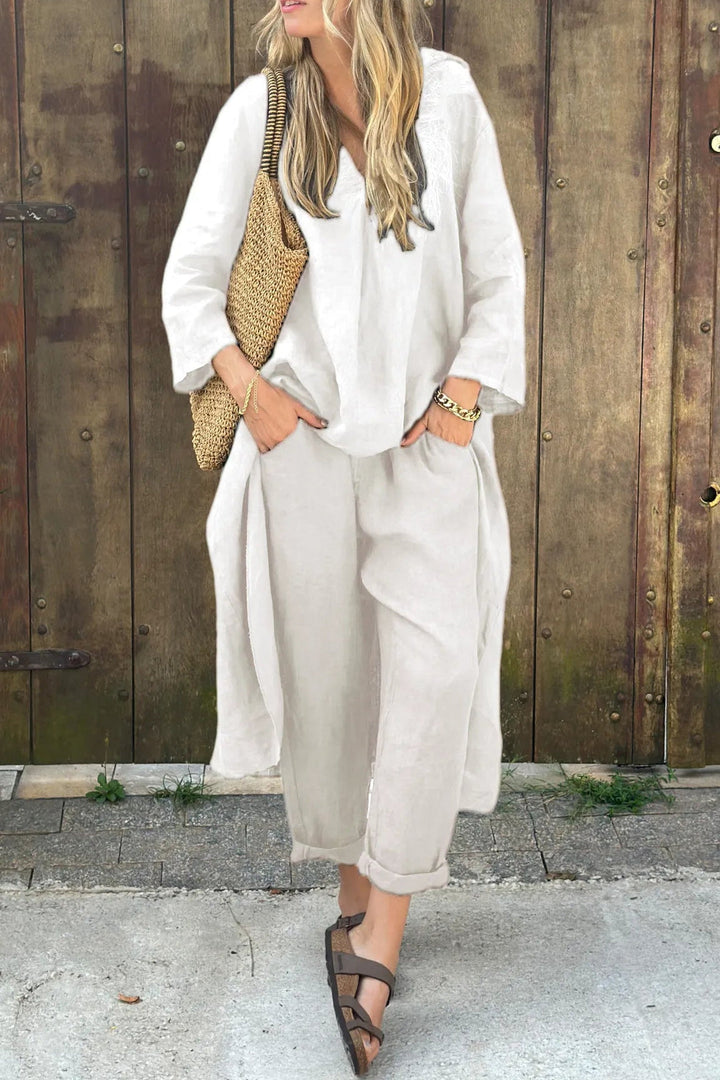 White chic outfit accessorized with woven bag in rustic setting.