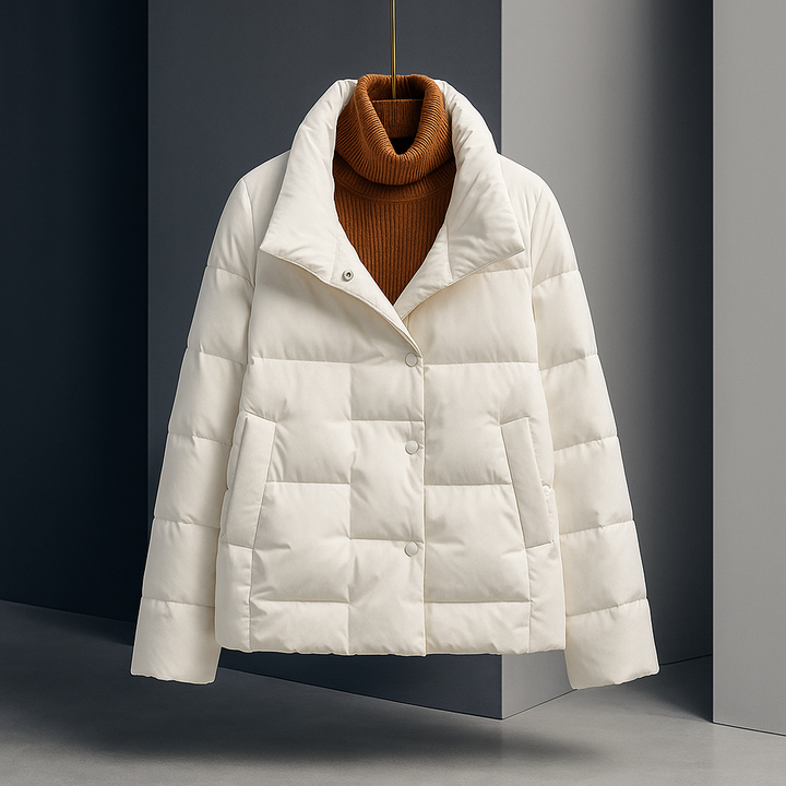 White quilted jacket with a brown turtleneck sweater, displayed in a modern indoor studio setting.