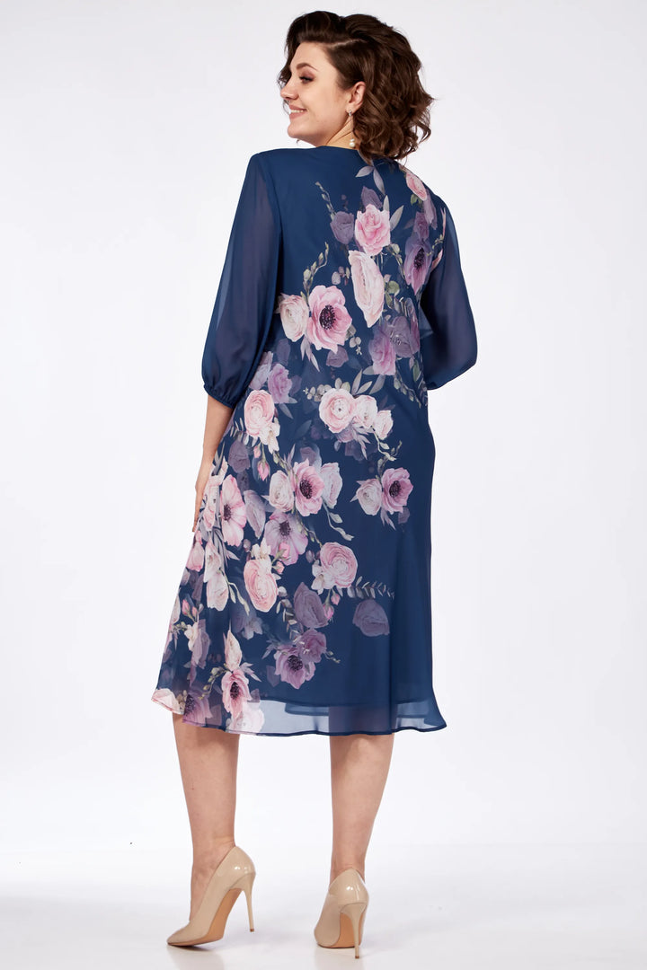 Back view of a navy floral dress with pink flowers, model in a studio setting.