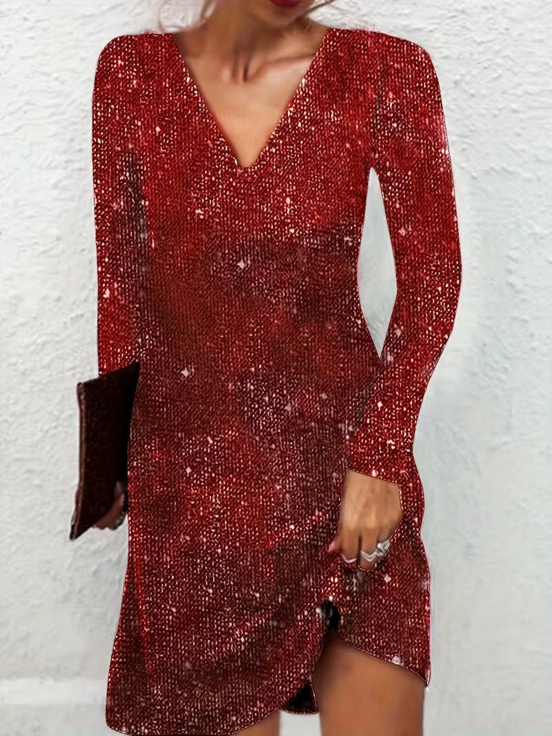 Red elegant midi dress with long sleeves and a V-neckline, worn by a person against a white wall backdrop.