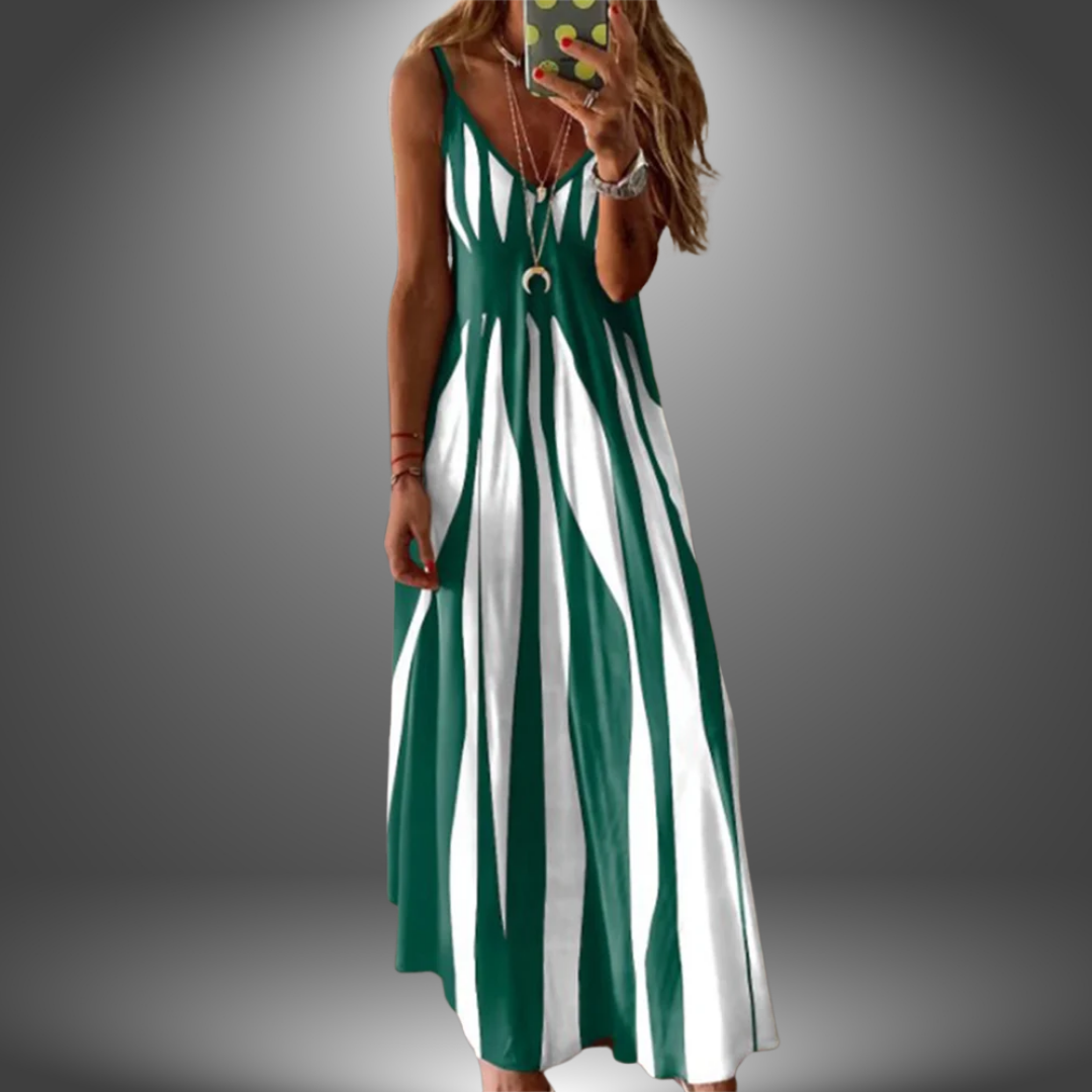 Dark green and white striped long dress with a flowing design, worn by a model taking a selfie in a studio setting.