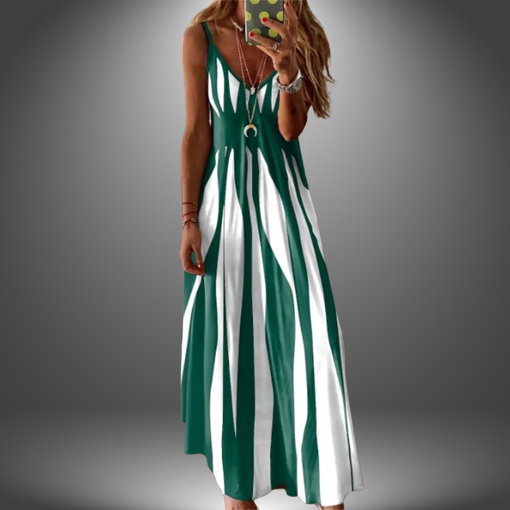 Dark green and white striped long dress with a flowing design, worn by a model taking a selfie in a studio setting.