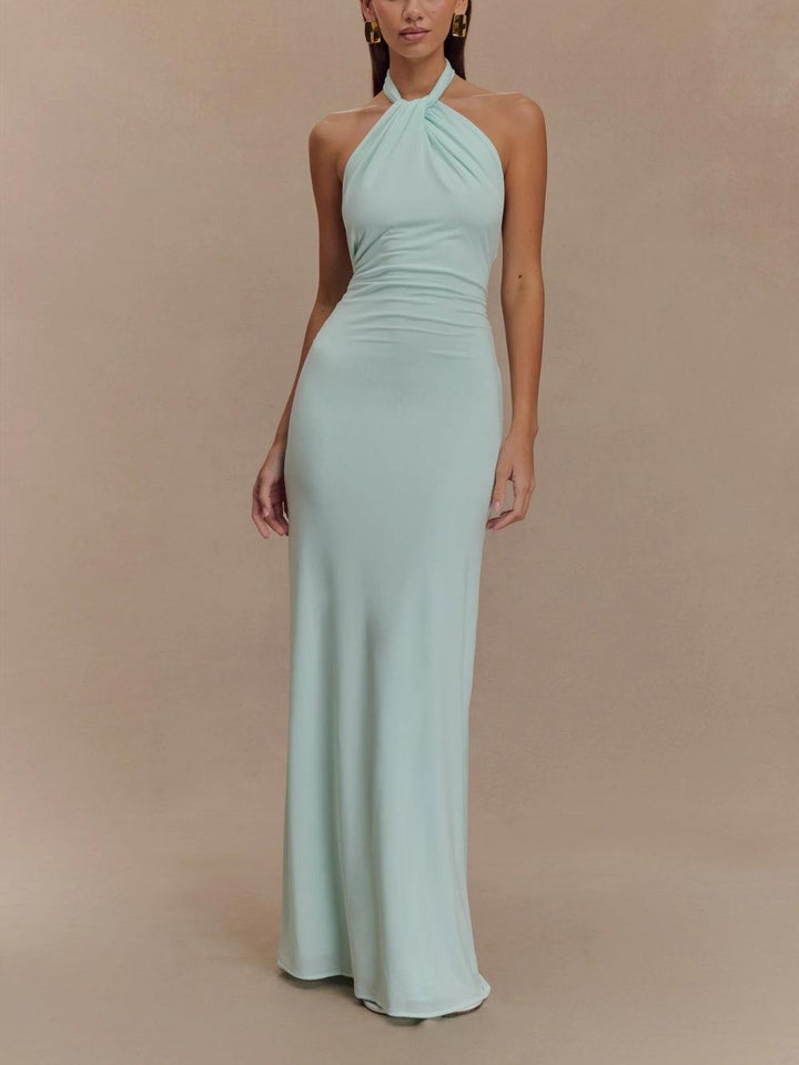 Model wearing a light mint green slinky halter maxi dress in a neutral studio setting.