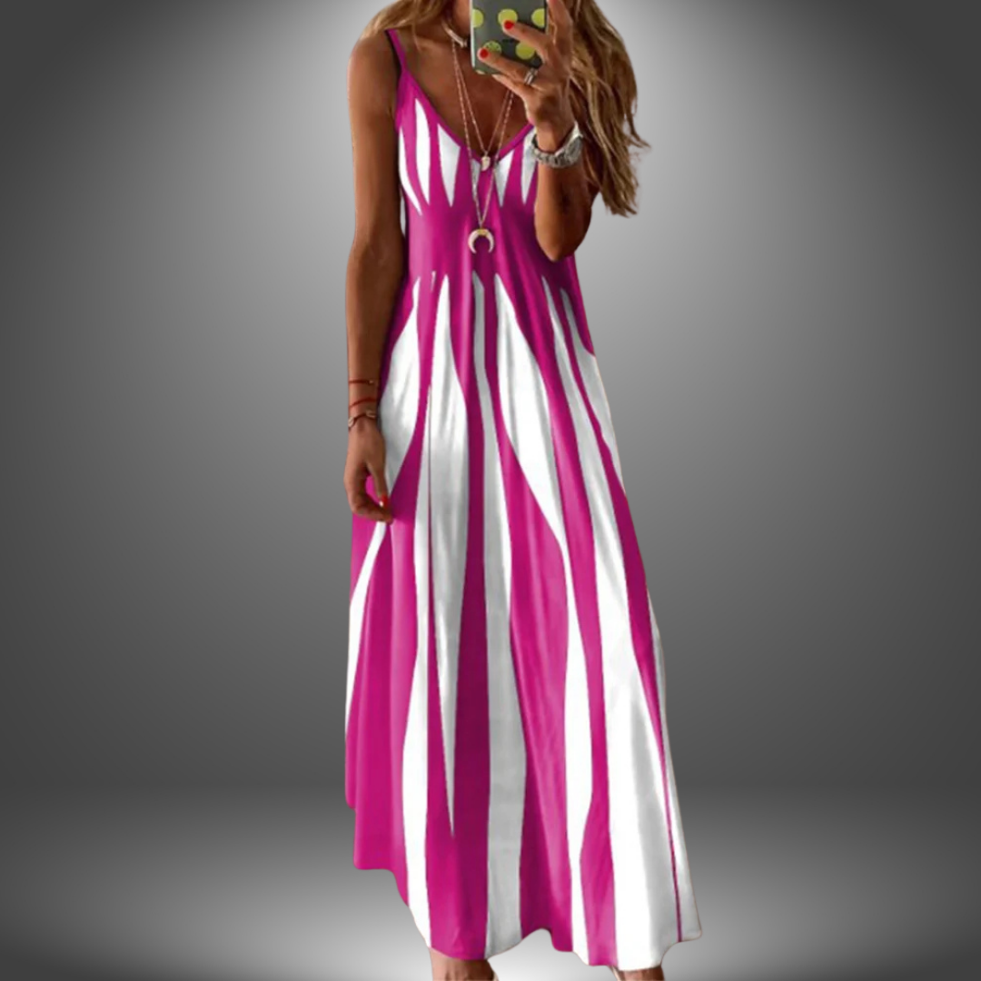 Pink and white striped long dress with a flowing design, worn by a model taking a selfie in a studio setting.