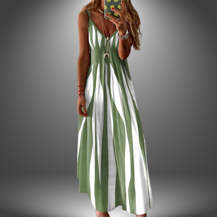 Light green and white striped long dress with a flowing design, worn by a model taking a selfie in a studio setting.