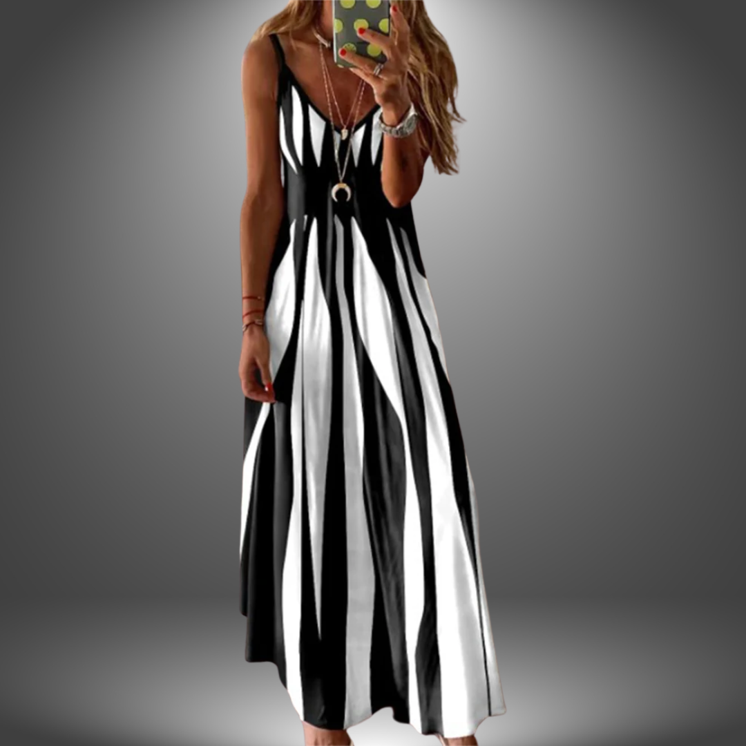 Black and white striped long dress with a flowing, casual design, worn by a model taking a selfie in a studio setting.