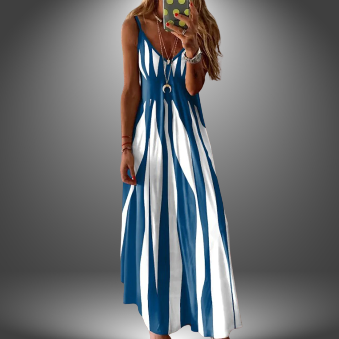 Blue and white striped long dress with a flowing design, worn by a model taking a selfie in a studio setting.