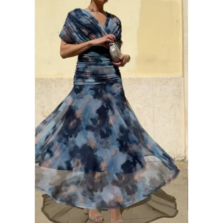 Woman wearing a blue floral corset dress twirling in a bright outdoor scene against a cream backdrop.