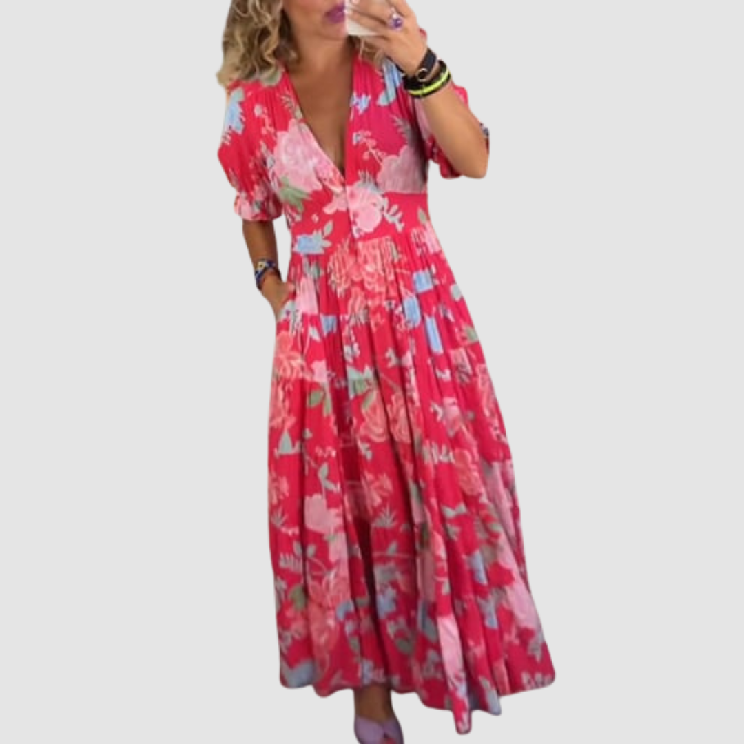 Red floral long dress worn indoors, showcasing a relaxed fit with short sleeves and a flowing skirt.