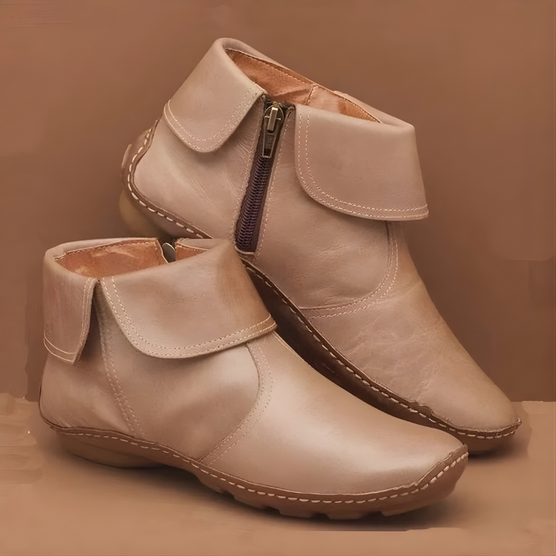 Beige orthopedic waterproof boots with side zippers on a matching colored background.