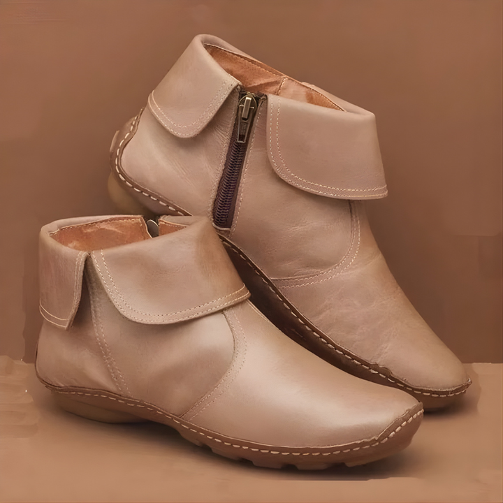 Beige orthopedic waterproof boots with side zippers on a matching colored background.