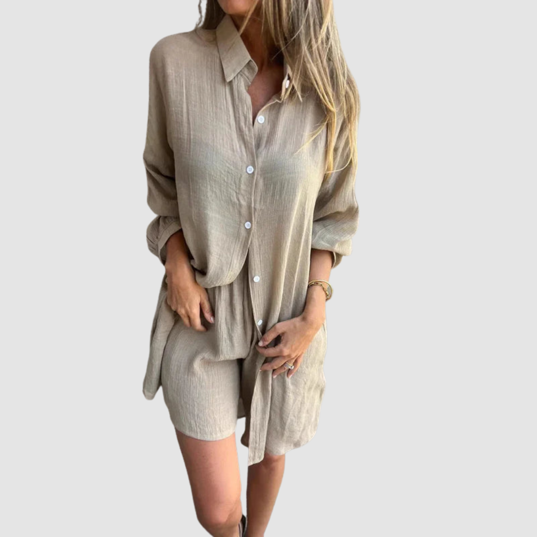 Model wearing a beige two-piece set with button-up shirt and shorts; neutral studio background.