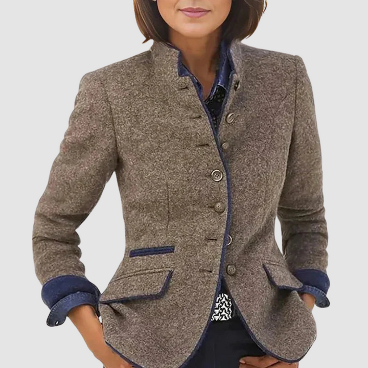 Women wearing a tailored, brown blazer with button details and blue accents, against a white background.