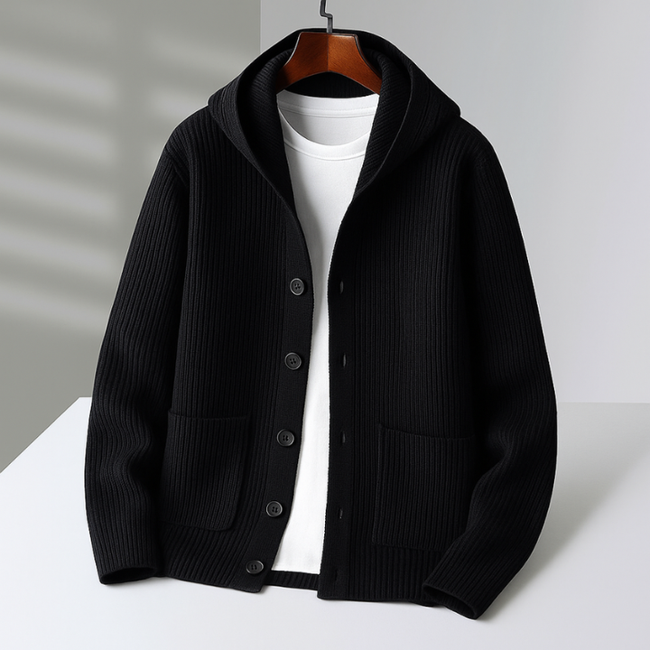 Black hooded cardigan with matching buttons on hanger in a bright studio setting.