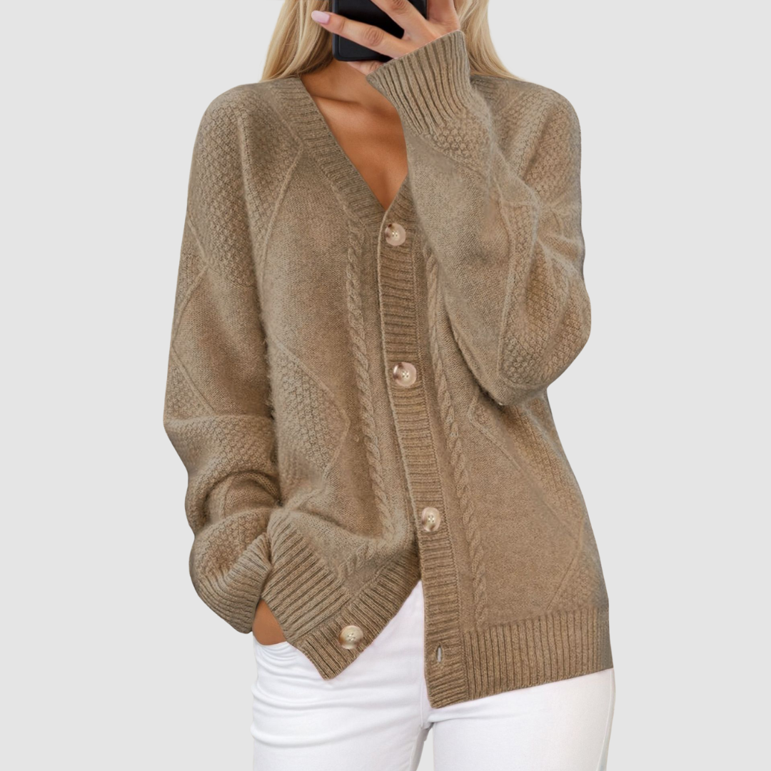 Brown knitted V-neck cardigan featuring buttons, worn by individual with hand in pocket, set against a light gray background.