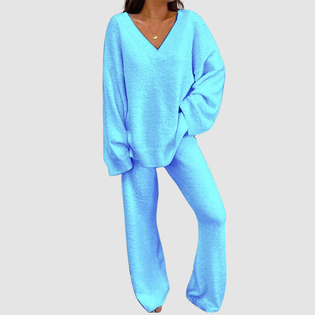 Blue V-neck long sleeve sweater and pants set on a person, posed against a plain white background.