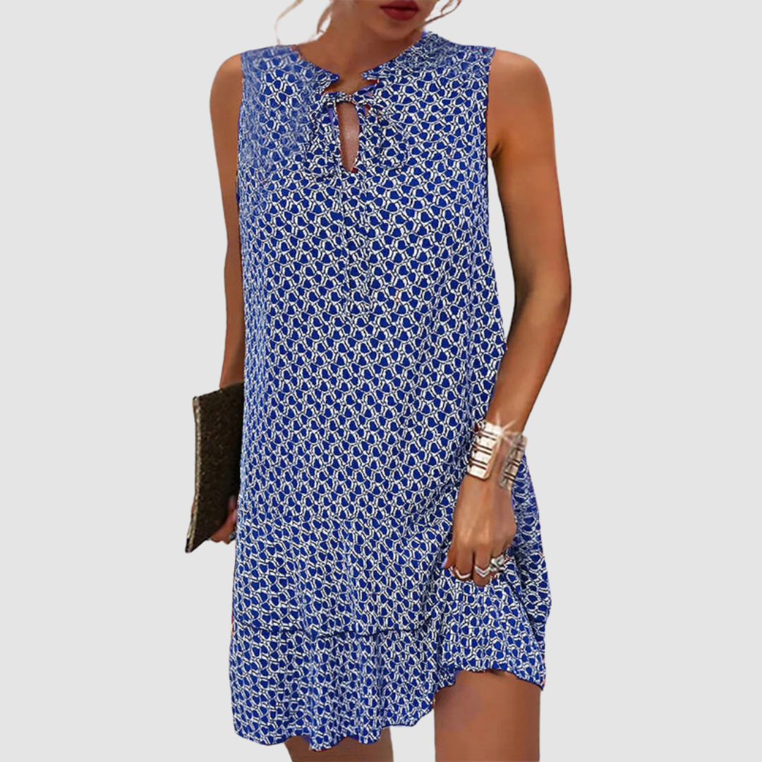Blue sleeveless dress with geometric pattern, keyhole neckline, white background.