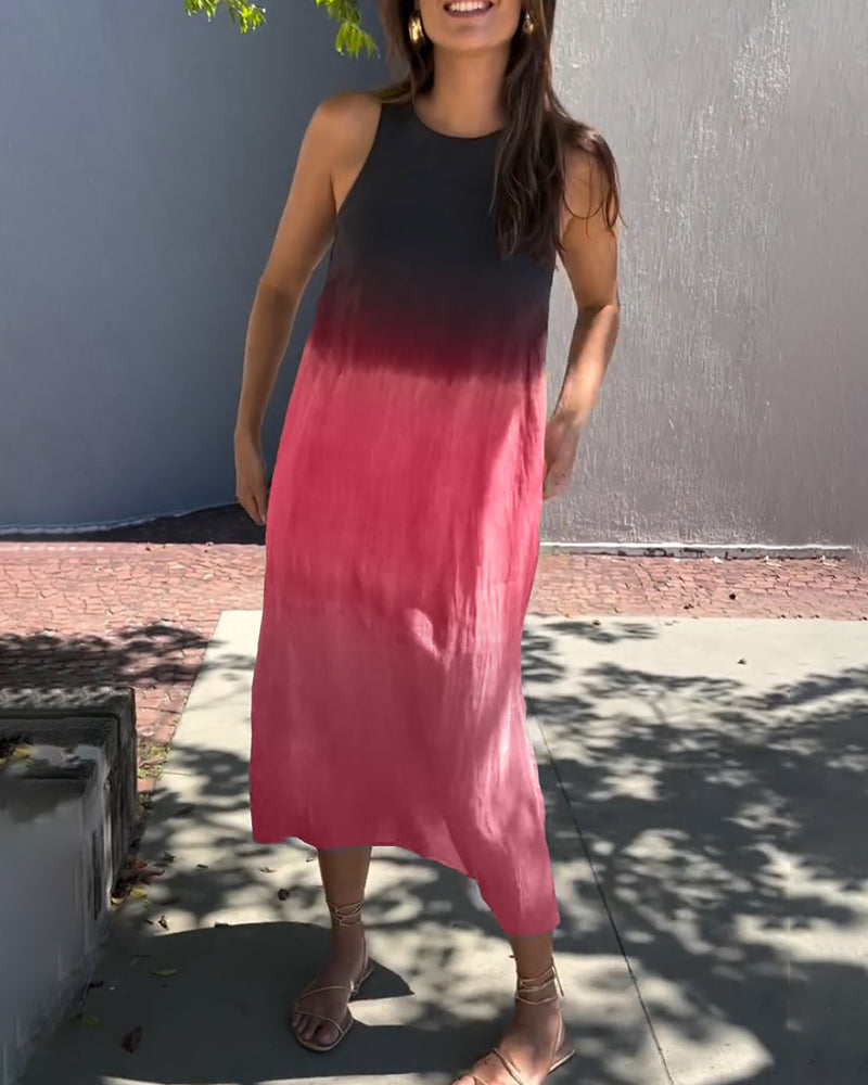 Woman wearing an ombre black to red sleeveless dress in a sunny outdoor area.