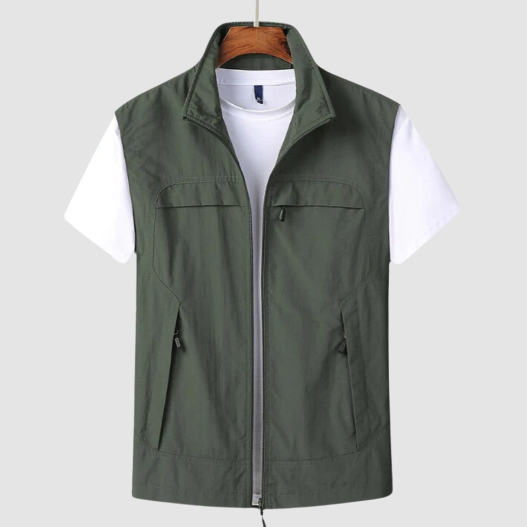 Olive green summer vest with zip front and pockets, over a white t-shirt, on a hanger against a gray background.
