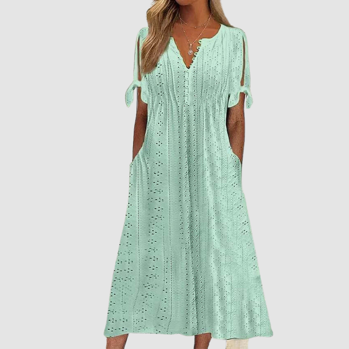 Mint green elegant casual dress featuring eyelet designs and tie sleeves, displayed in a studio setting.