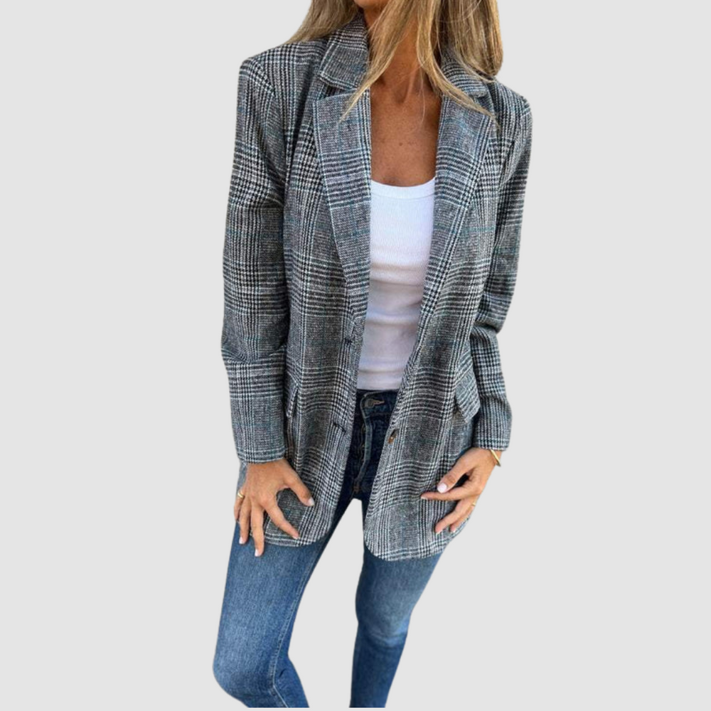 Modeled plaid winter blazer in gray tones worn over a white top and denim jeans against a plain background.