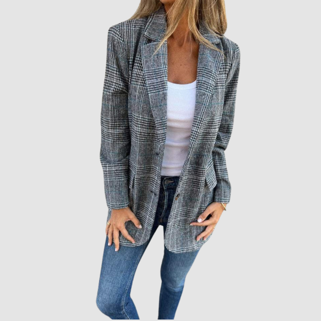 Modeled plaid winter blazer in gray tones worn over a white top and denim jeans against a plain background.