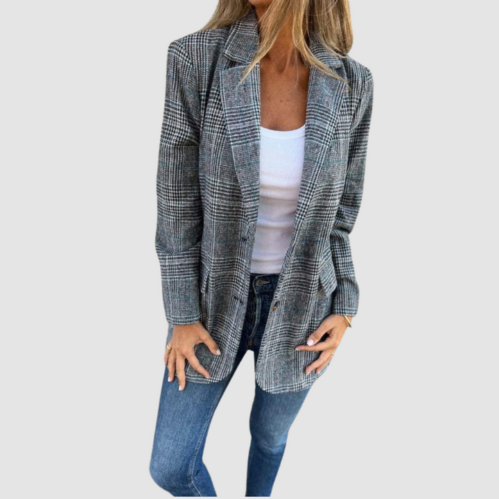 Modeled plaid winter blazer in gray tones worn over a white top and denim jeans against a plain background.