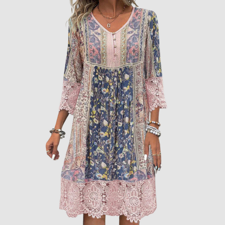 Boho dress with colorful floral pattern and lace trim, worn by model, shown from the front against a plain backdrop.