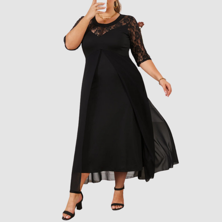 Elegant black dress with lace detailing, styled with black heels, in a studio environment.