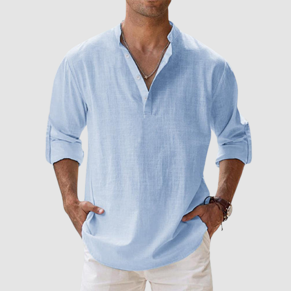 Light blue long-sleeve breathable shirt with banded collar, button placket, white pants in studio.