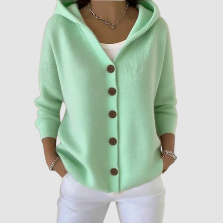 Mint green hooded cardigan with brown buttons, worn over a white top, against a light gray background.
