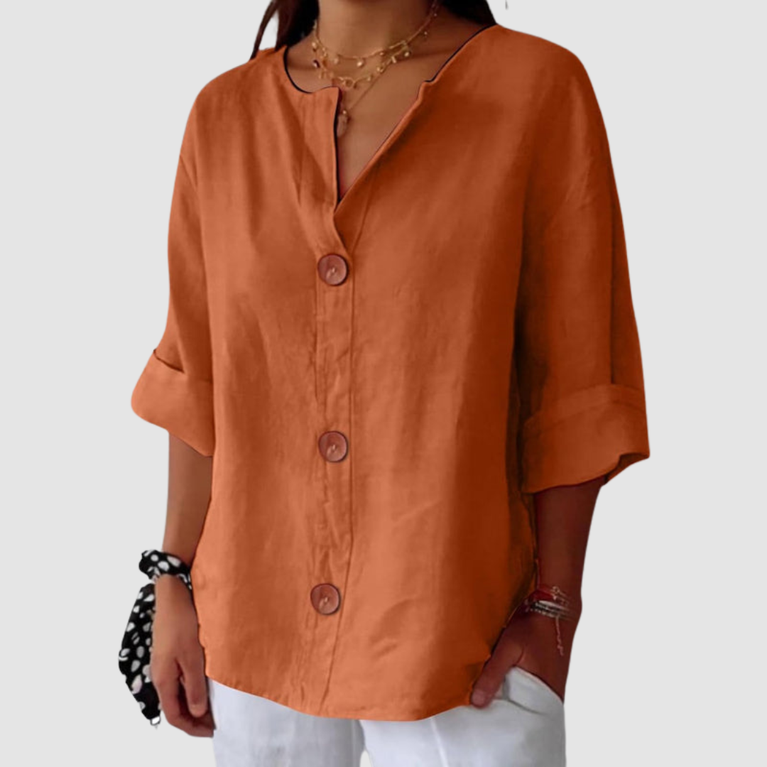Orange casual blouse with large buttons, half sleeves, against a plain white background.