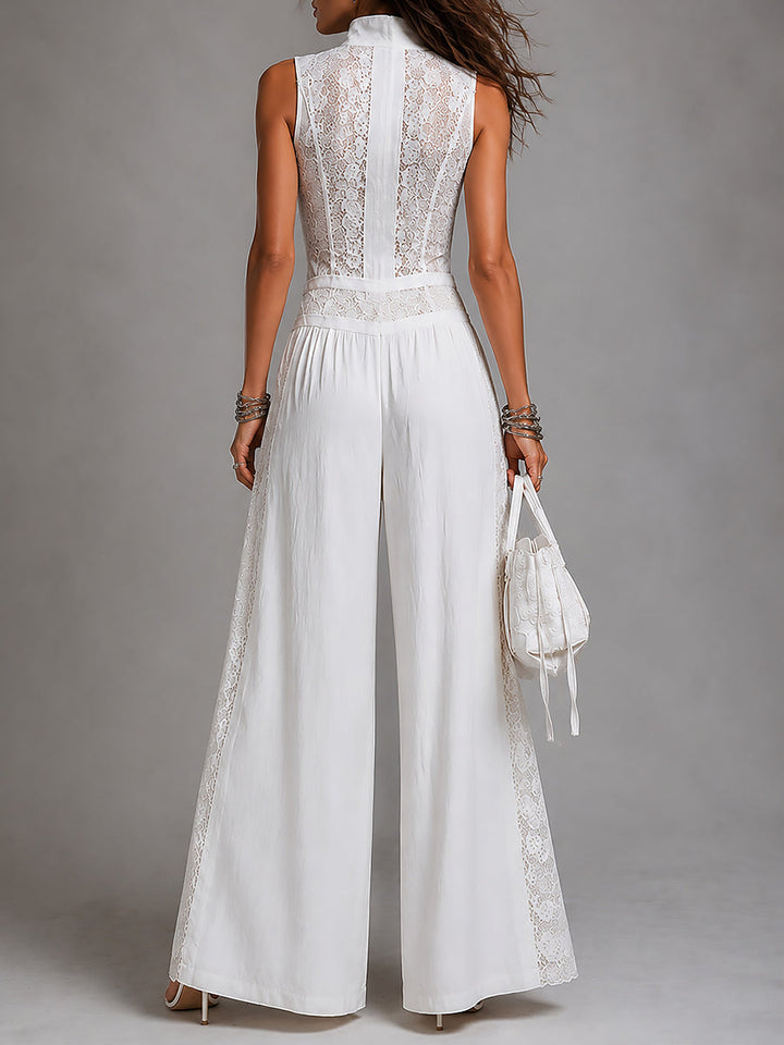 Rear view of white wide-leg jumpsuit with lace detailing, displayed in a studio.