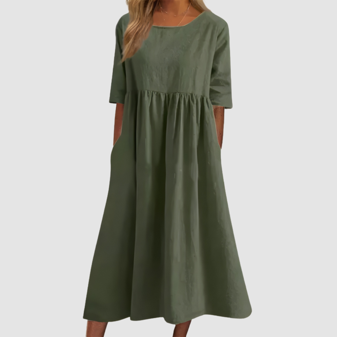Olive green breezy dress with elbow-length sleeves in a studio setting.