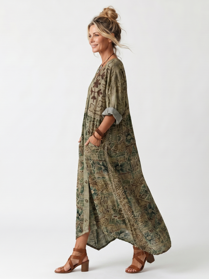 Side view of model in Aleta button-front midi dress with detailed patterns, oversized pockets, studio backdrop.
