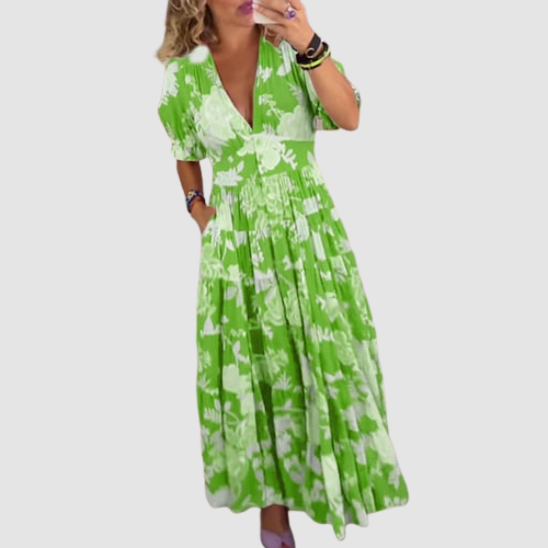 Green floral long dress worn indoors, emphasizing a relaxed fit with a full and flowing skirt.