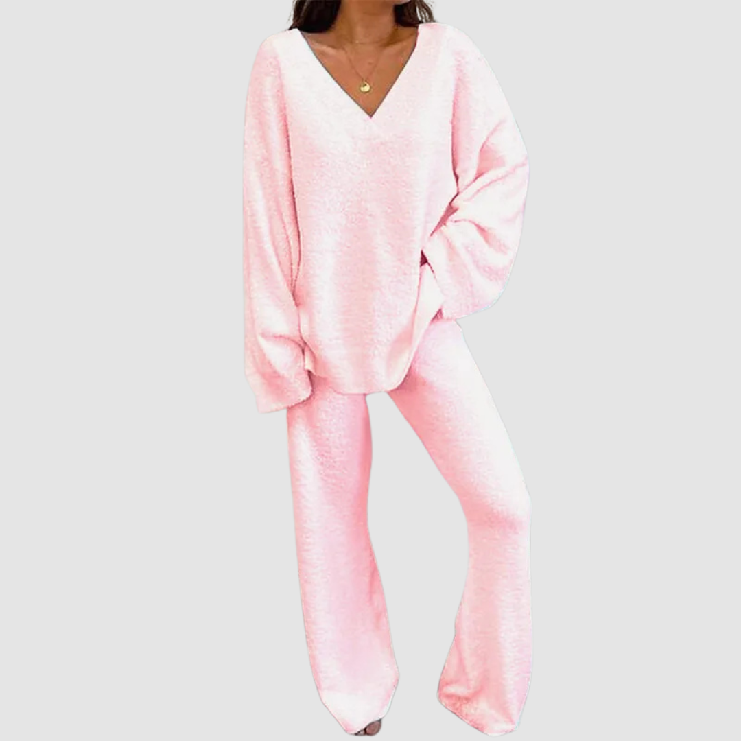 Pink V-neck long sleeve sweater and pants set on a person, posed against a plain white background.