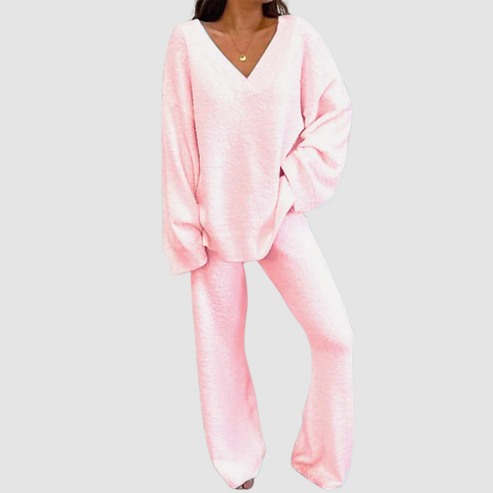 Pink V-neck long sleeve sweater and pants set on a person, posed against a plain white background.