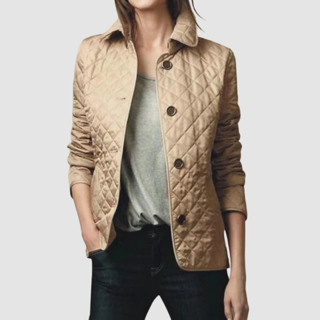 Beige quilted jacket with buttons, worn over gray top and jeans by a model, light background.