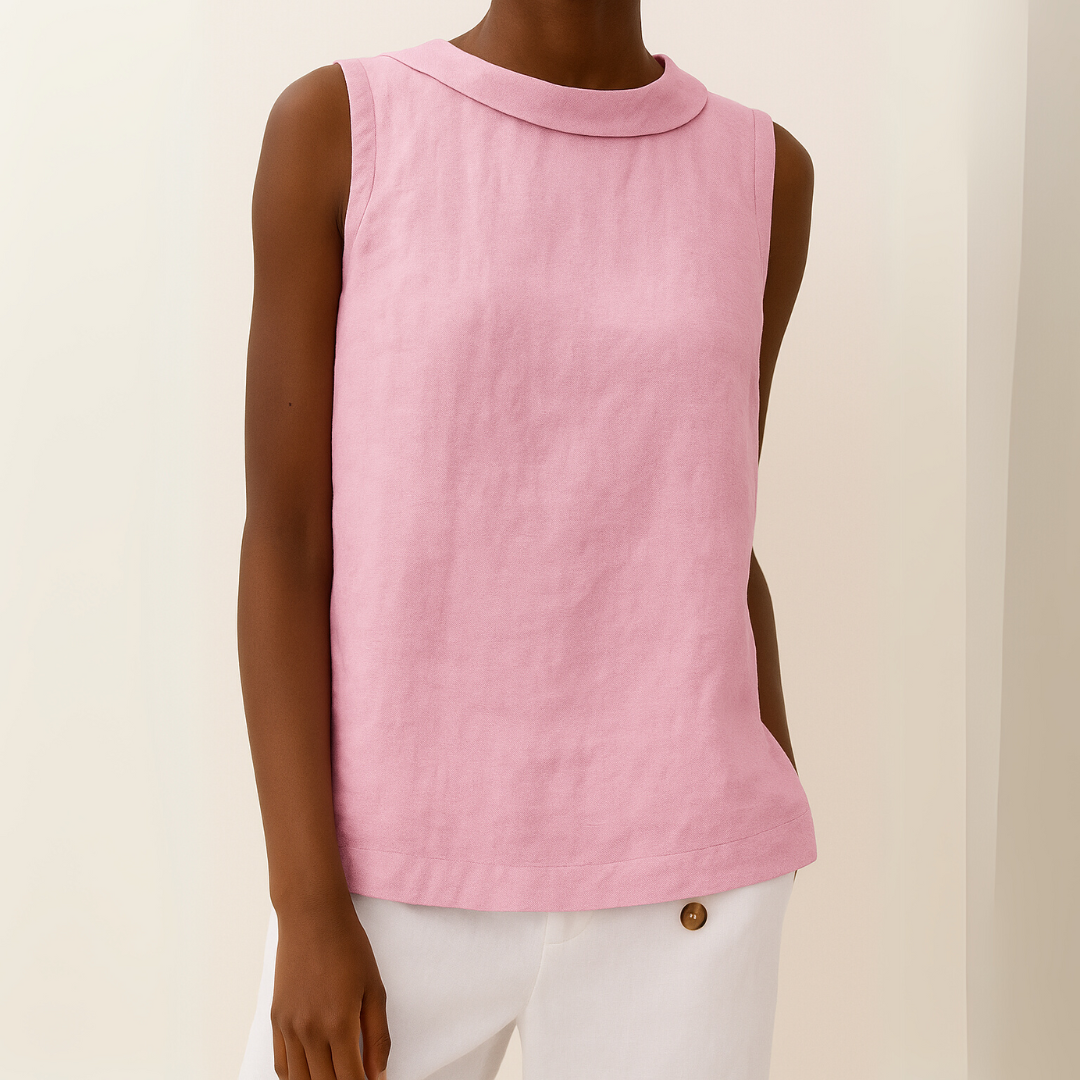 Pink sleeveless top with roll collar on model, paired with white pants, against a light background.