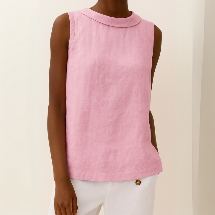 Pink sleeveless top with roll collar on model, paired with white pants, against a light background.