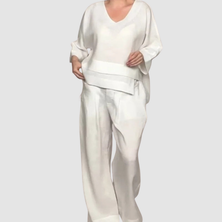 White relaxed 2-piece set with V-neck top and wide-leg pants, studio background.