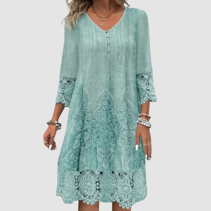 Stylish teal lace dress featuring V-neck, button accent, ornate lace detailing on hem and sleeves, studio background.