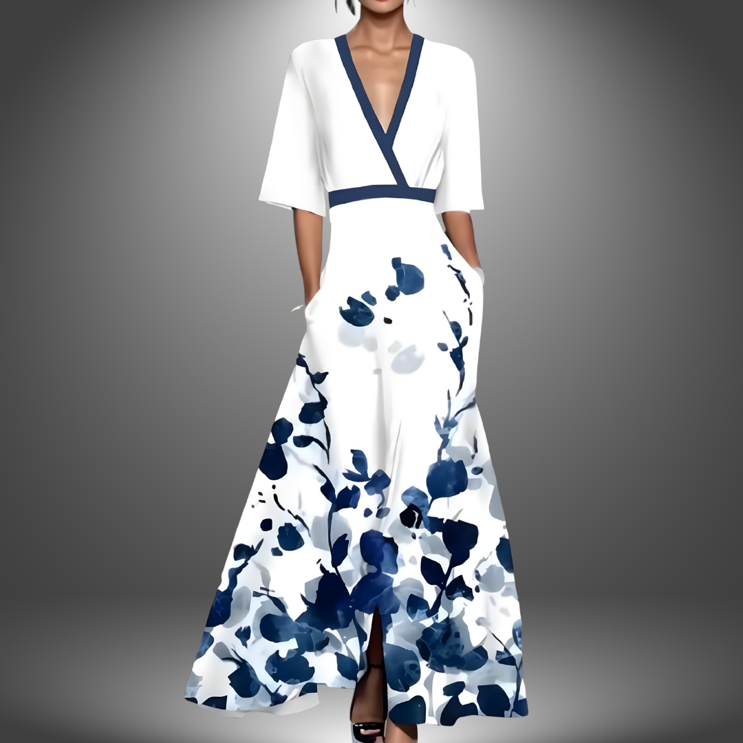White dress with blue floral design, V-neck, short sleeves, studio background.