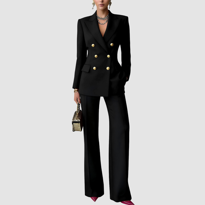 Elegant black tailored set with gold buttons, structured blazer, wide-leg pants, complementing jewelry and metallic handbag on a gray background.