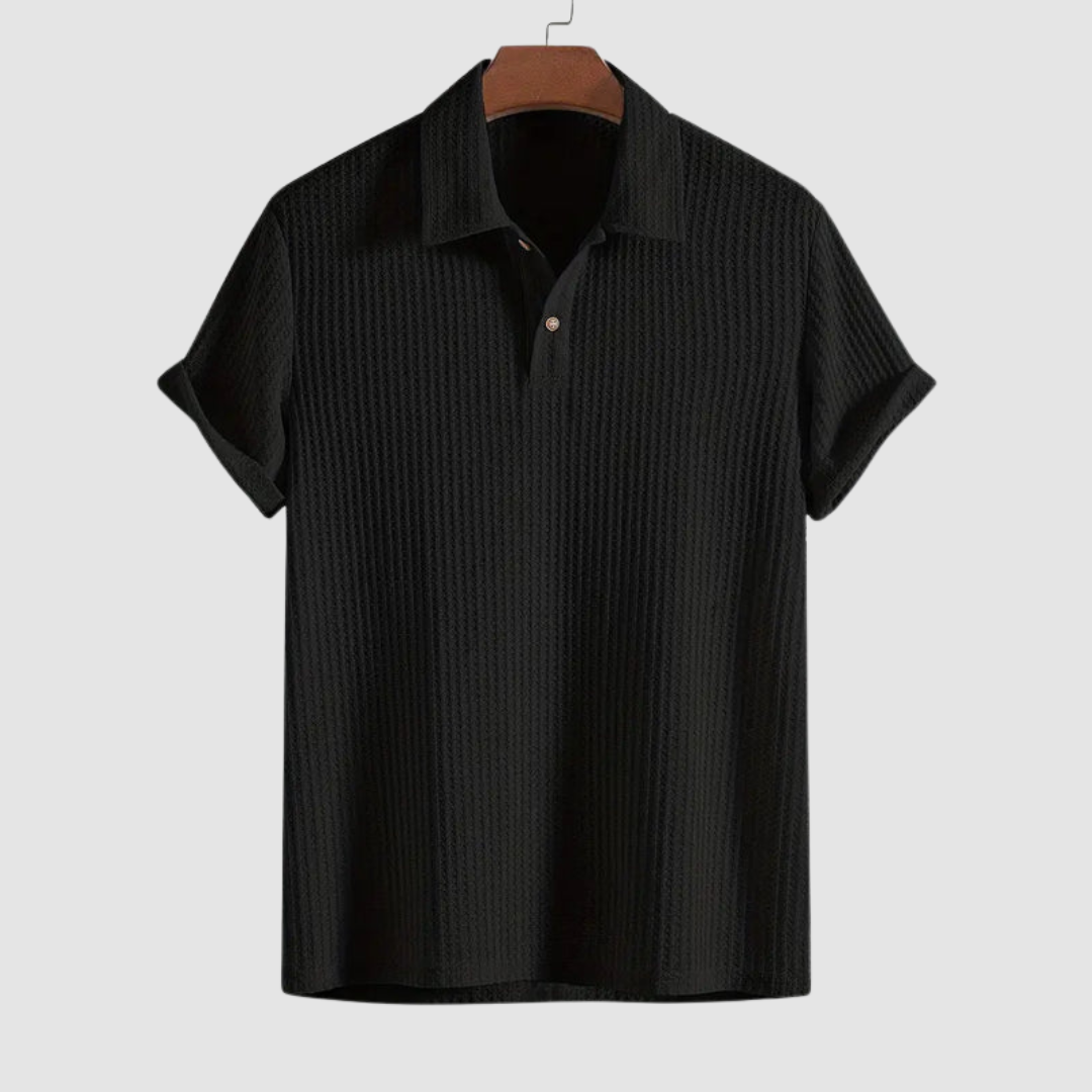 Black textured polo shirt on a hanger against a plain light gray background.