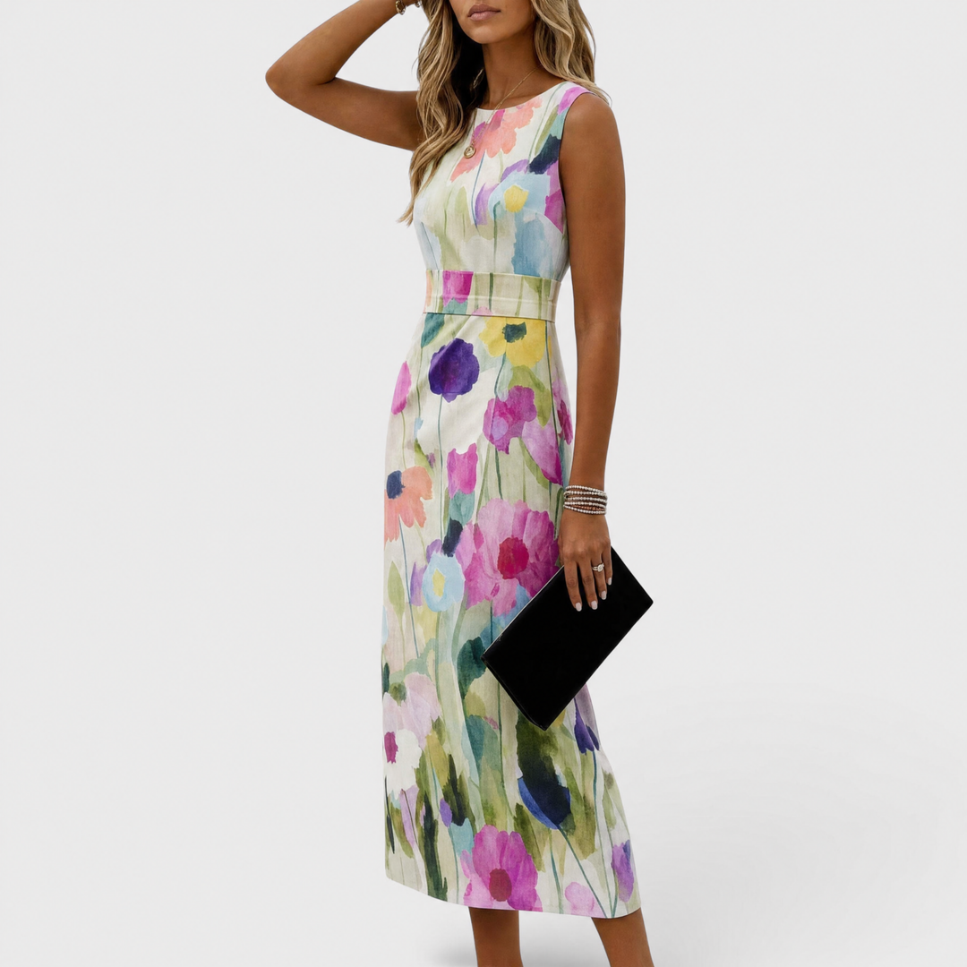 Side view of woman in floral midi dress, with colorful flowers, holding black clutch in studio.