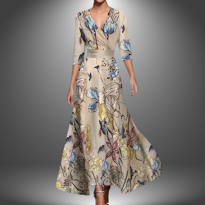 Woman in a long, flowing dress with delicate pastel floral print, set against a soft gradient studio background.