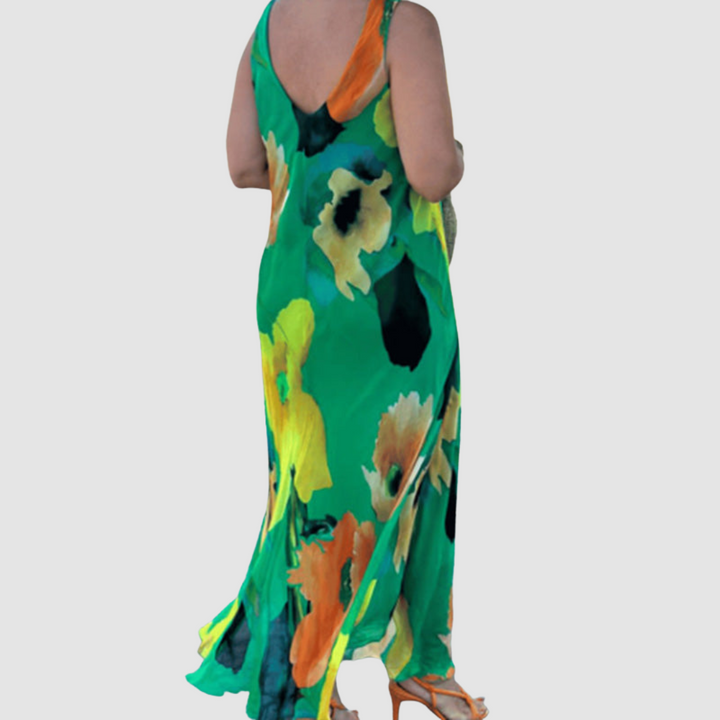 Back view of a green floral sleeveless dress with a relaxed fit, displayed on a plain background.